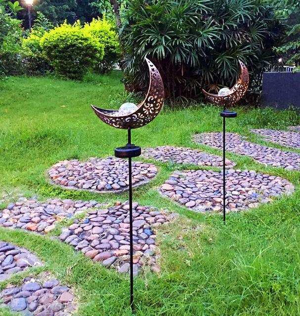 LED Solar Flame Light in decorative flame design illuminating garden at night.