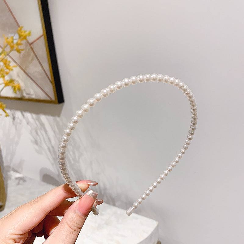 Thin pearl headbands with imitation pearls and metal, shown in a variety of designs.