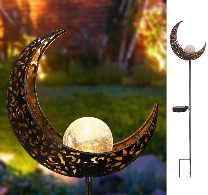 LED Solar Flame Light in decorative flame design illuminating garden at night.