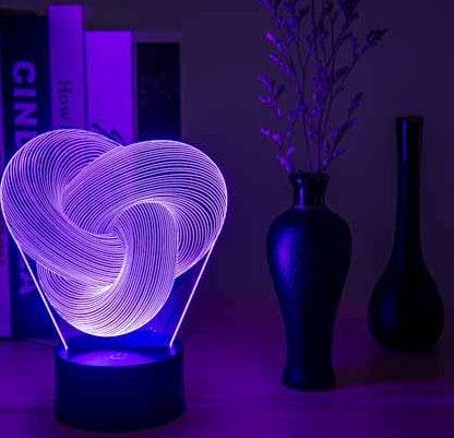 Twist Abstract LED 3D night light on a table with decorative vases, emitting a soft glow.