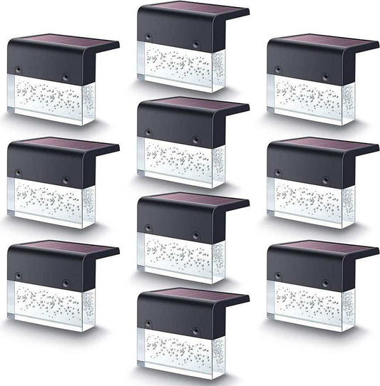 Waterproof New RGB RGB LED solar step lights illuminating a garden fence in multiple colors, waterproof and crystal-like for outdoor decoration.