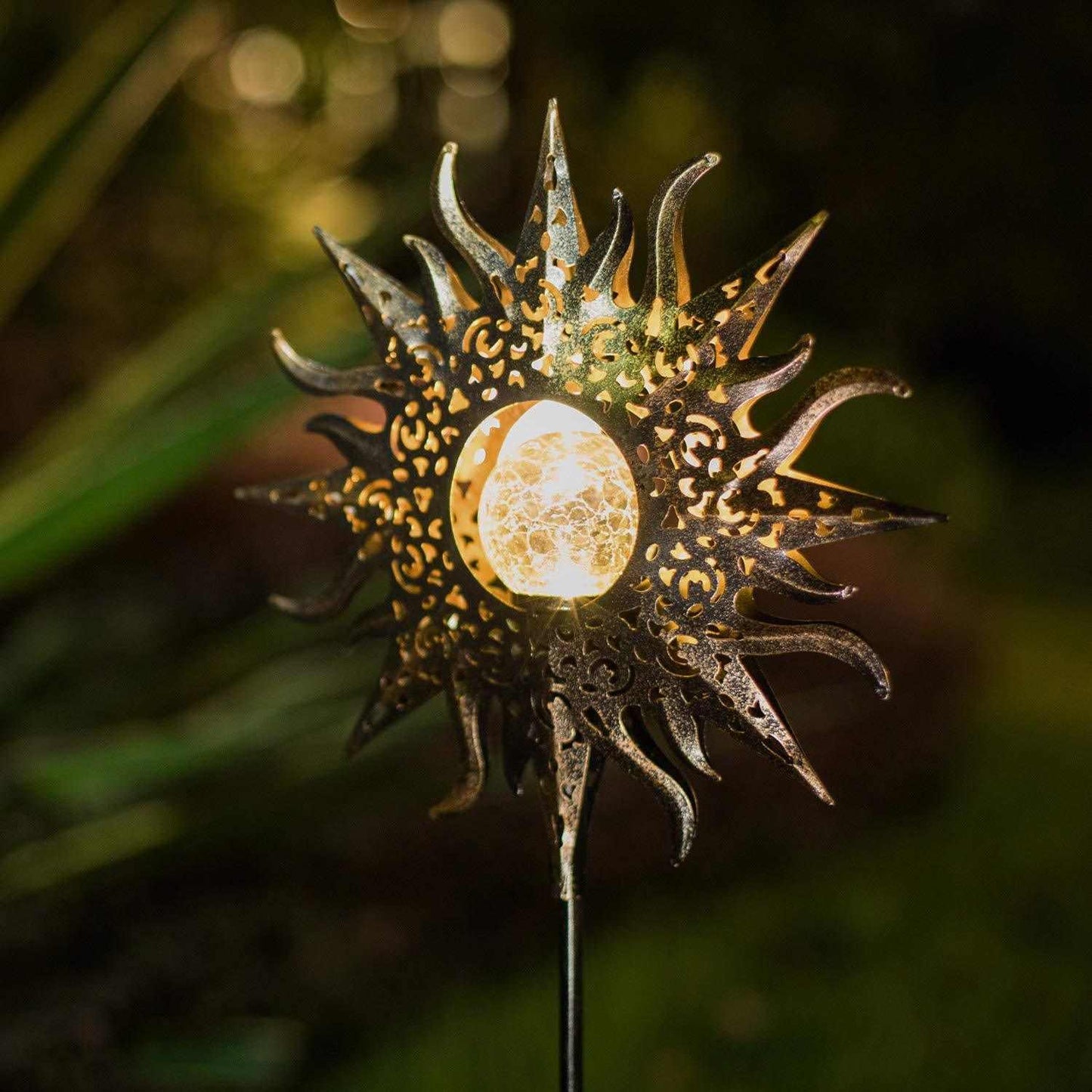 LED Solar Flame Light in decorative flame design illuminating garden at night.