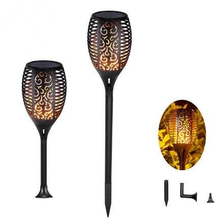 Outdoor pathway illuminated by LED waterproof solar torch lights with warm, flickering glow.