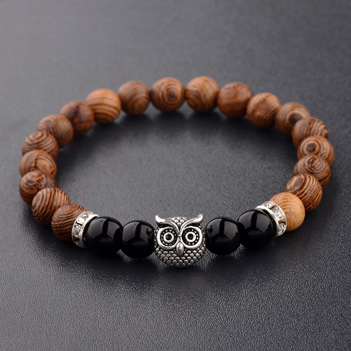 Exotic owl frosted stone bracelet with wood beads in black and gold.