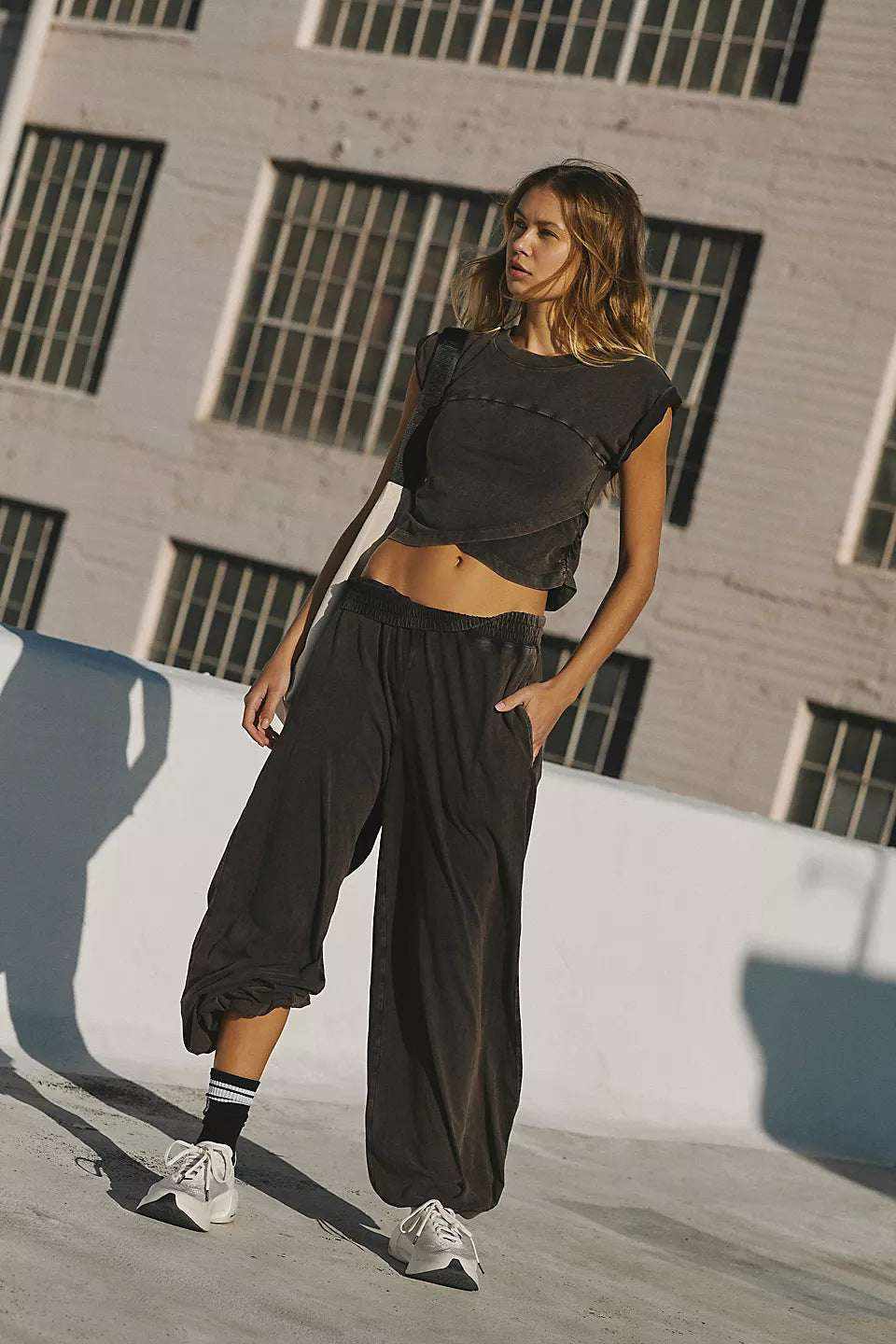 Ladies two-piece set with sleeveless top and sweatpants, dark color, casual style.