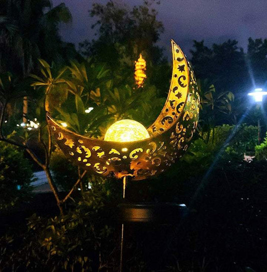LED Solar Flame Light in decorative flame design illuminating garden at night.