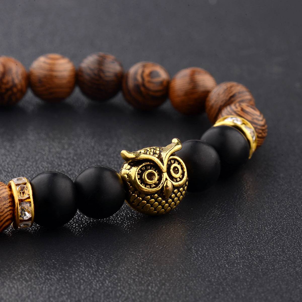 Exotic owl frosted stone bracelet with wood beads in black and gold.