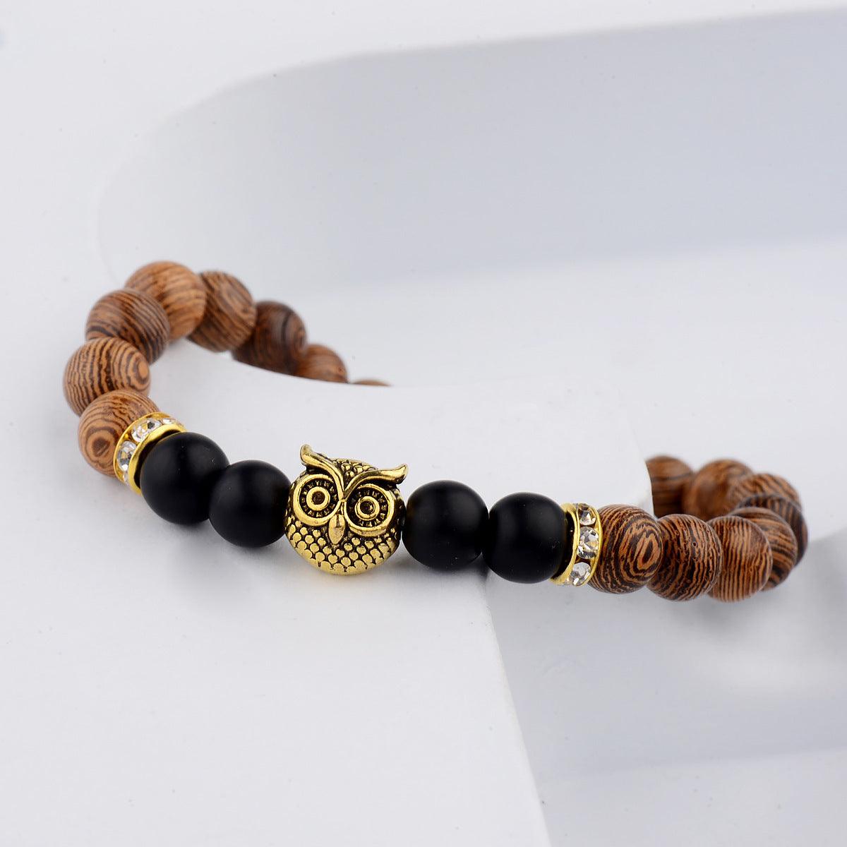 Exotic owl frosted stone bracelet with wood beads in black and gold.
