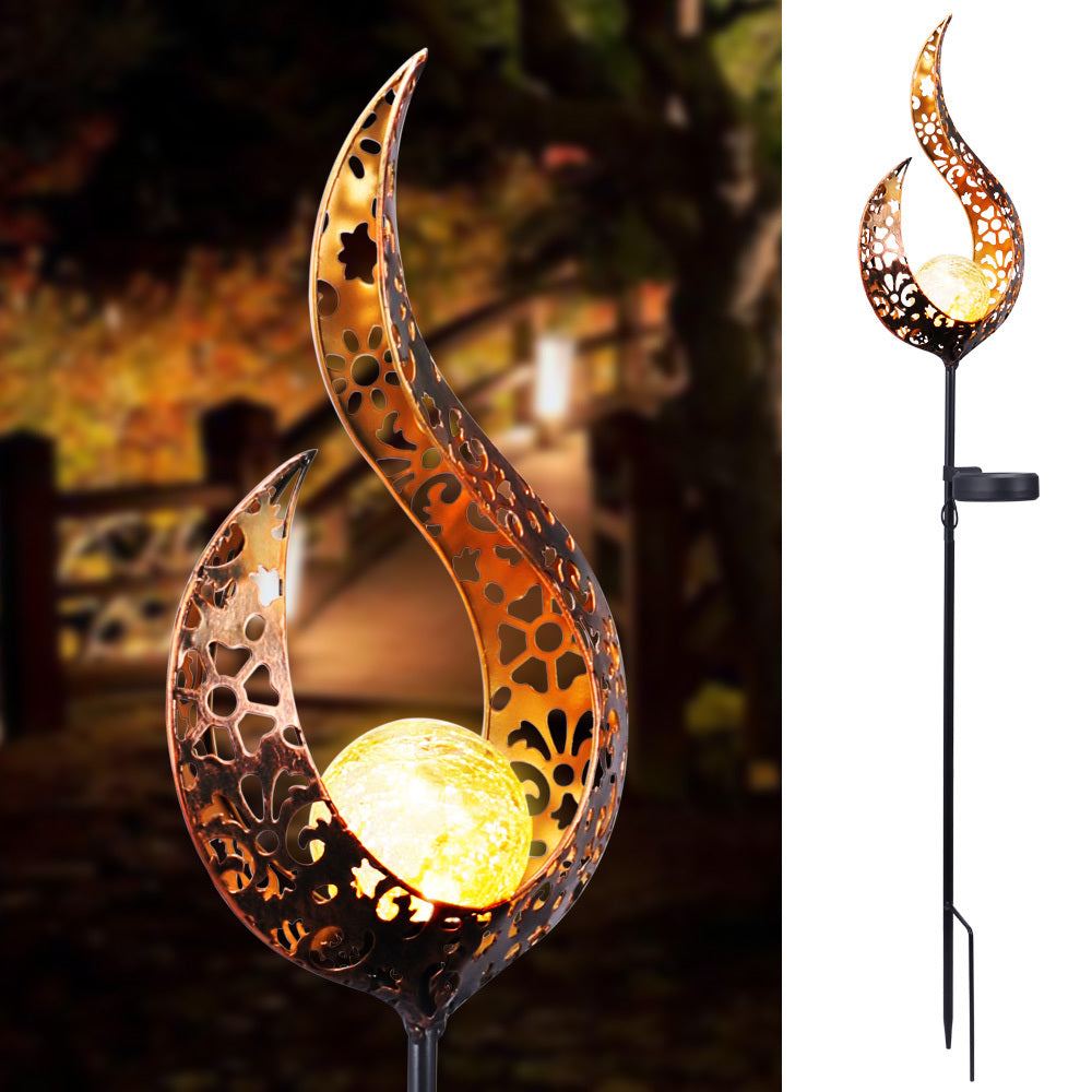 LED Solar Flame Light in decorative flame design illuminating garden at night.