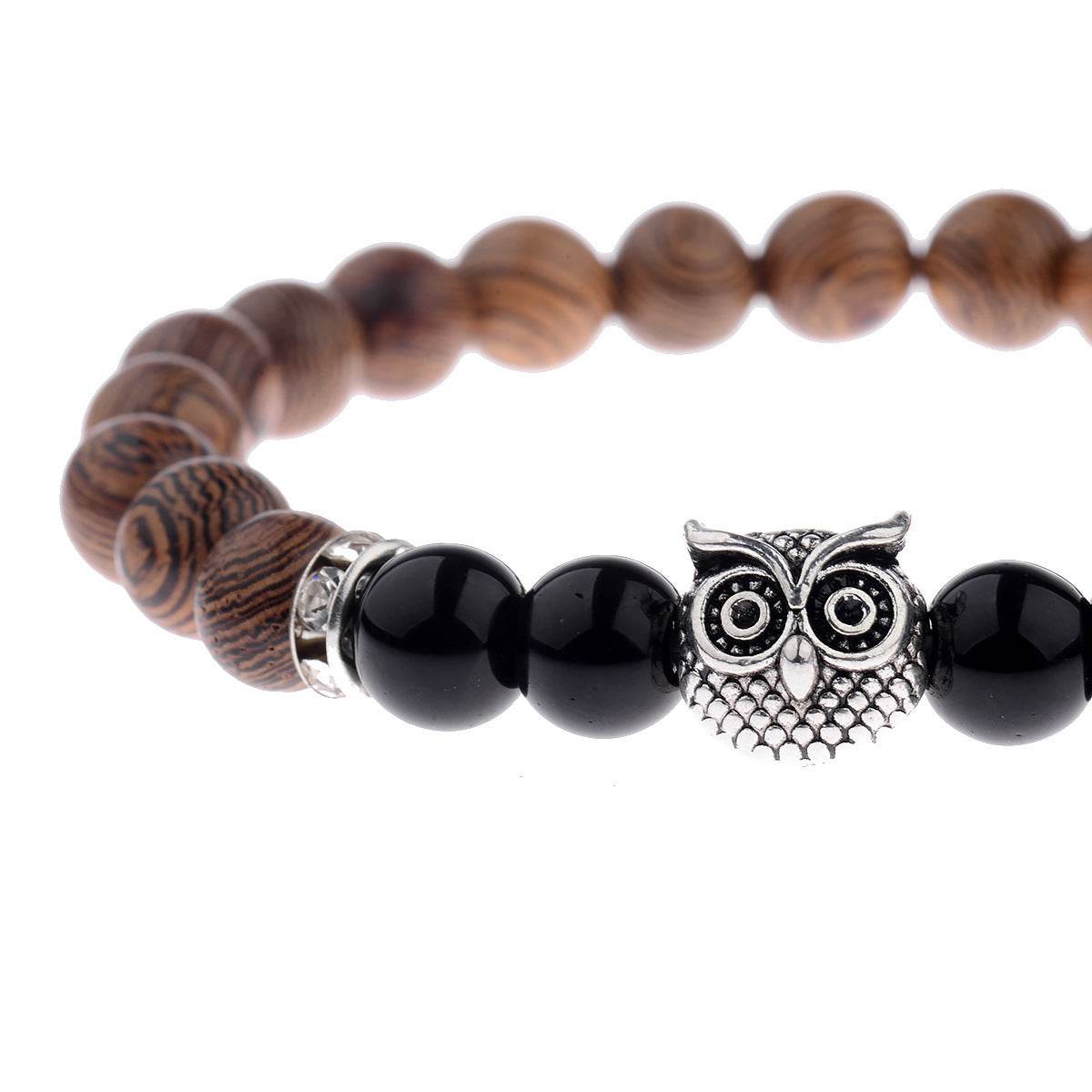 Exotic owl frosted stone bracelet with wood beads in black and gold.