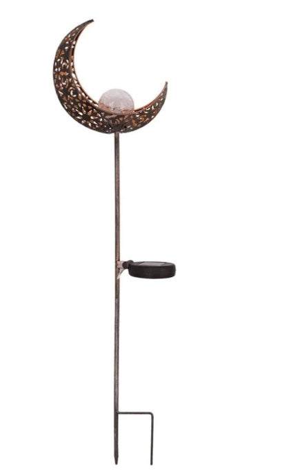 LED Solar Flame Light in decorative flame design illuminating garden at night.