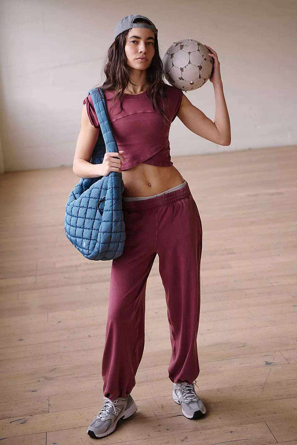 Ladies two-piece set with sleeveless top and sweatpants, dark color, casual style.
