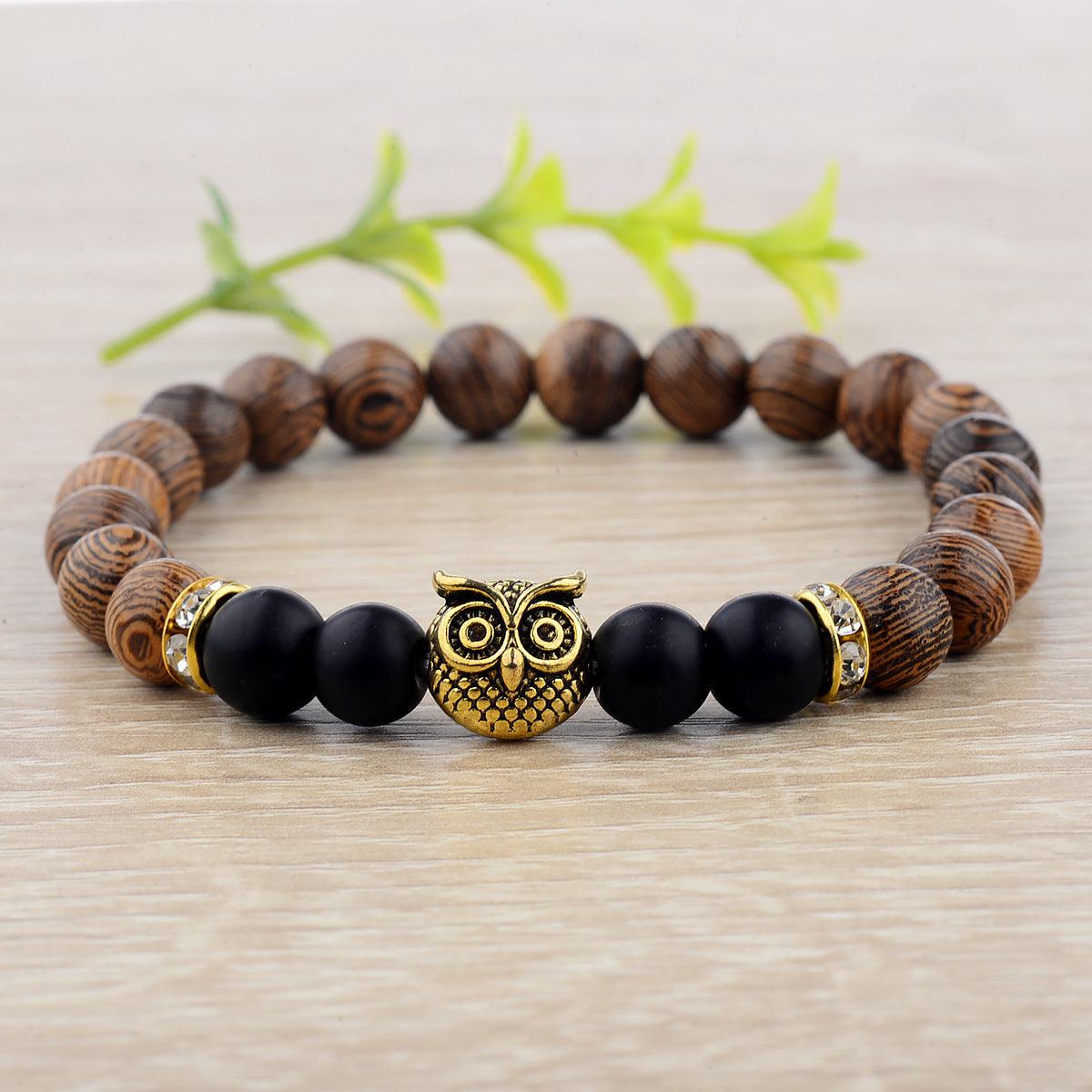 Exotic owl frosted stone bracelet with wood beads in black and gold.