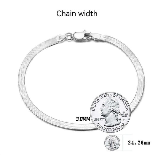 S925 sterling silver flat snake bone bracelet in platinum color, worn on wrist.