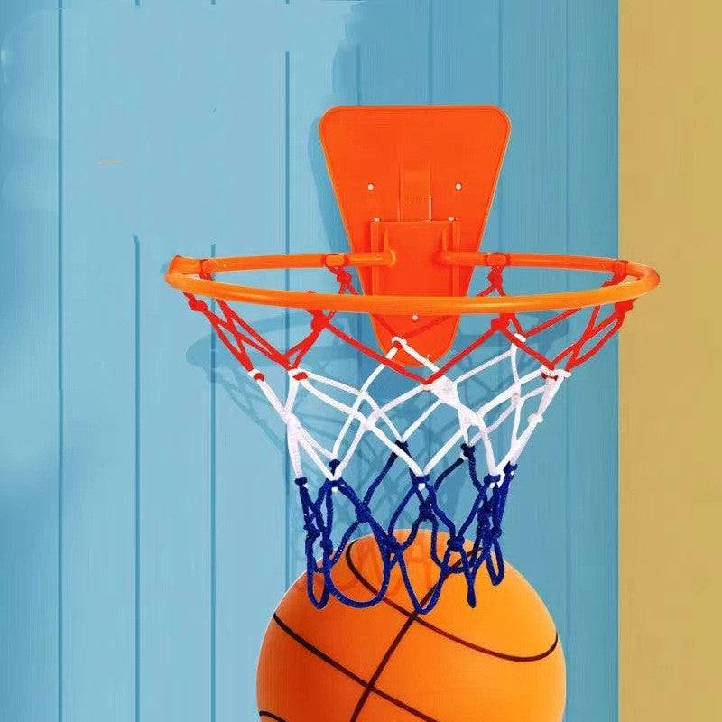 Child playing with Silent Sports Ball indoor basketball set, featuring vibrant bouncy balls in various colors and a hoop.