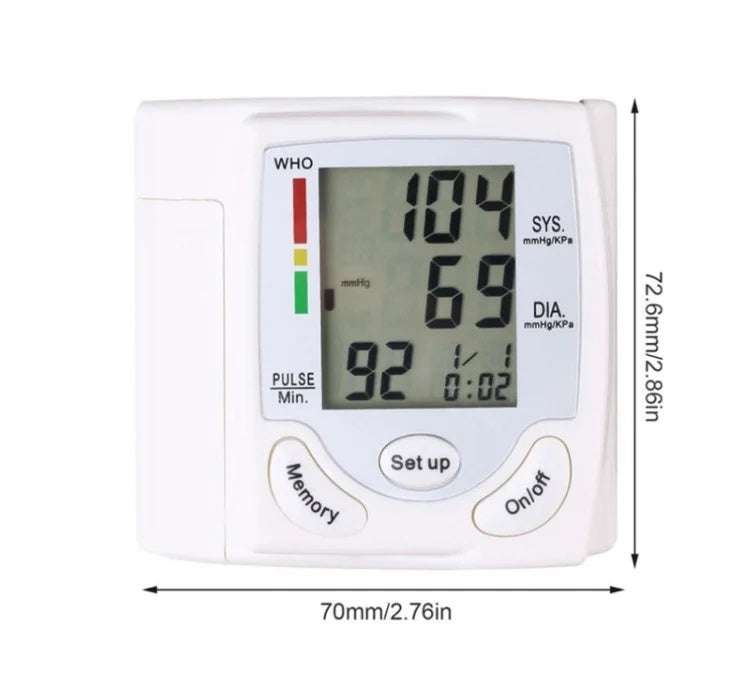 Wrist blood pressure monitor displaying readings on a person's wrist.
