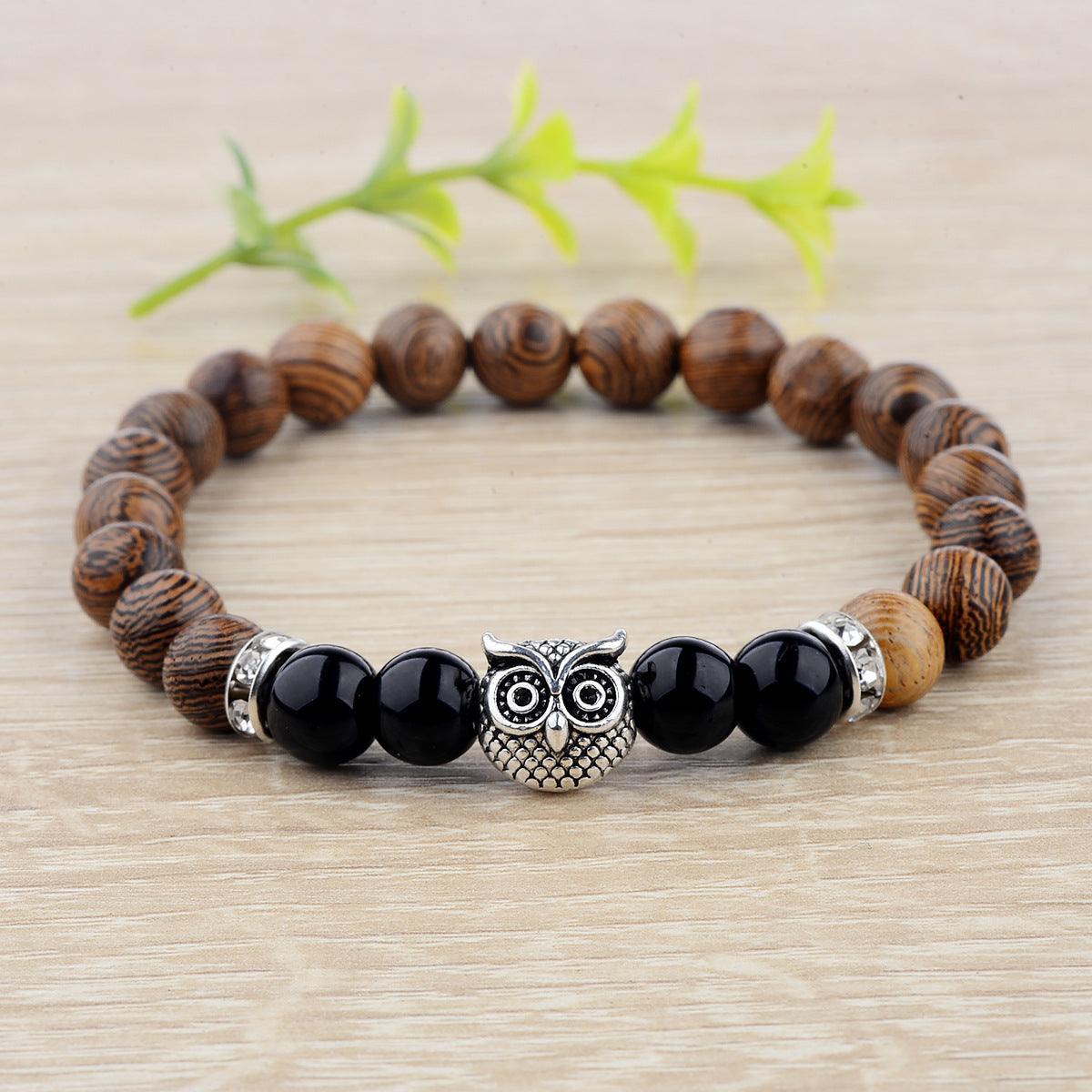 Exotic owl frosted stone bracelet with wood beads in black and gold.