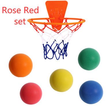 Child playing with Silent Sports Ball indoor basketball set, featuring vibrant bouncy balls in various colors and a hoop.