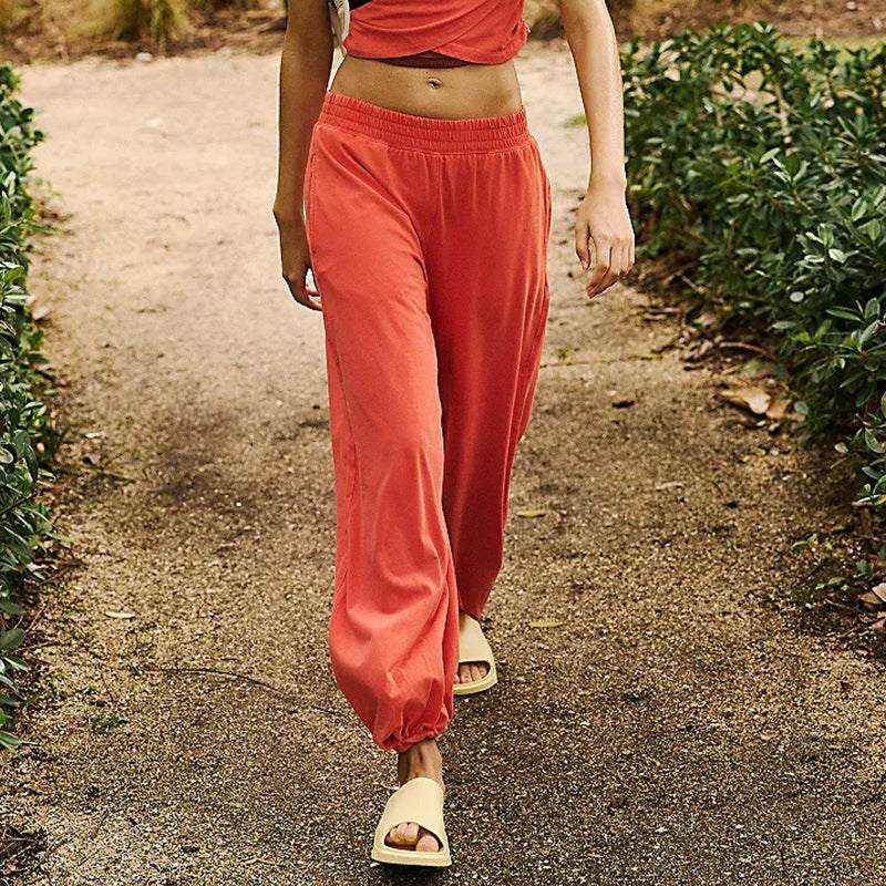 Ladies two-piece set with sleeveless top and sweatpants, dark color, casual style.