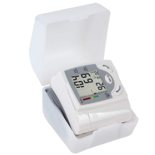 Wrist blood pressure monitor displaying readings on a person's wrist.