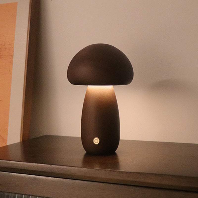 Wooden cute mushroom LED night lights on a bedside table, suitable for children's room decor.