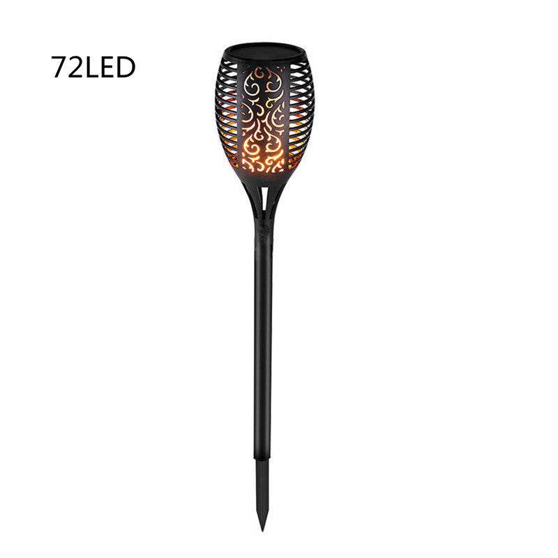 Outdoor pathway illuminated by LED waterproof solar torch lights with warm, flickering glow.
