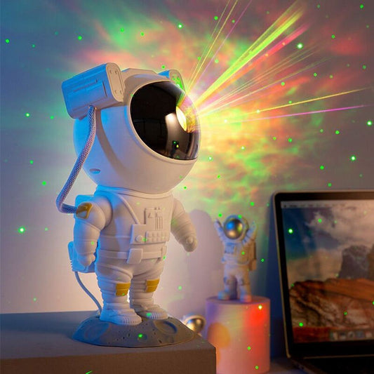 Astronaut-shaped galaxy starry sky projector lamp casting colorful nebula effects on walls.