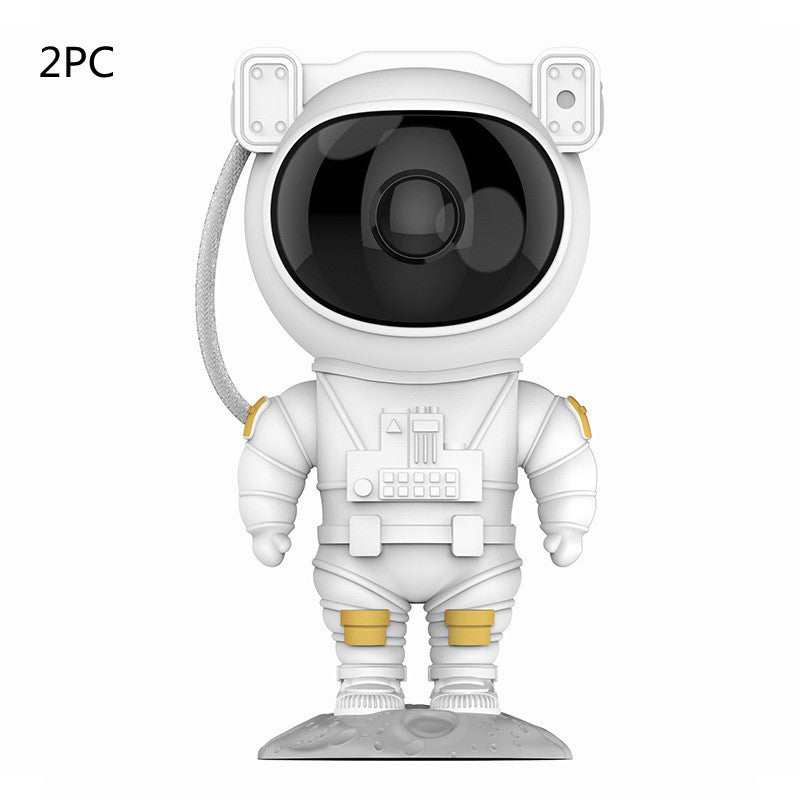 Astronaut-shaped galaxy starry sky projector lamp casting colorful nebula effects on walls.