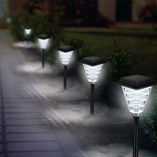 Solar garden lights illuminating a pathway at night.
