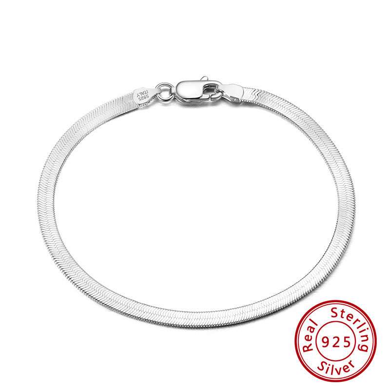 S925 sterling silver flat snake bone bracelet in platinum color, worn on wrist.