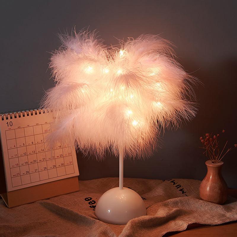 Nordic feather lamp with warm LED lights on a wooden base, perfect for bedroom decoration.