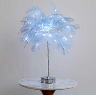 Nordic feather lamp with warm LED lights on a wooden base, perfect for bedroom decoration.