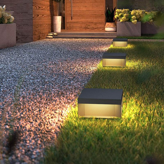 Waterproof solar garden lights illuminating a gravel pathway.