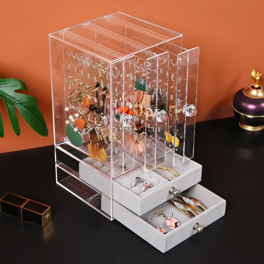 Acrylic cosmetic storage box with clear plastic design and multiple compartments for organizing makeup.