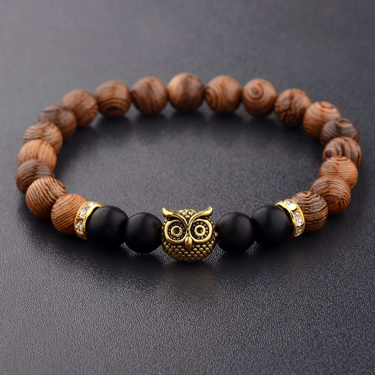 Exotic owl frosted stone bracelet with wood beads in black and gold.