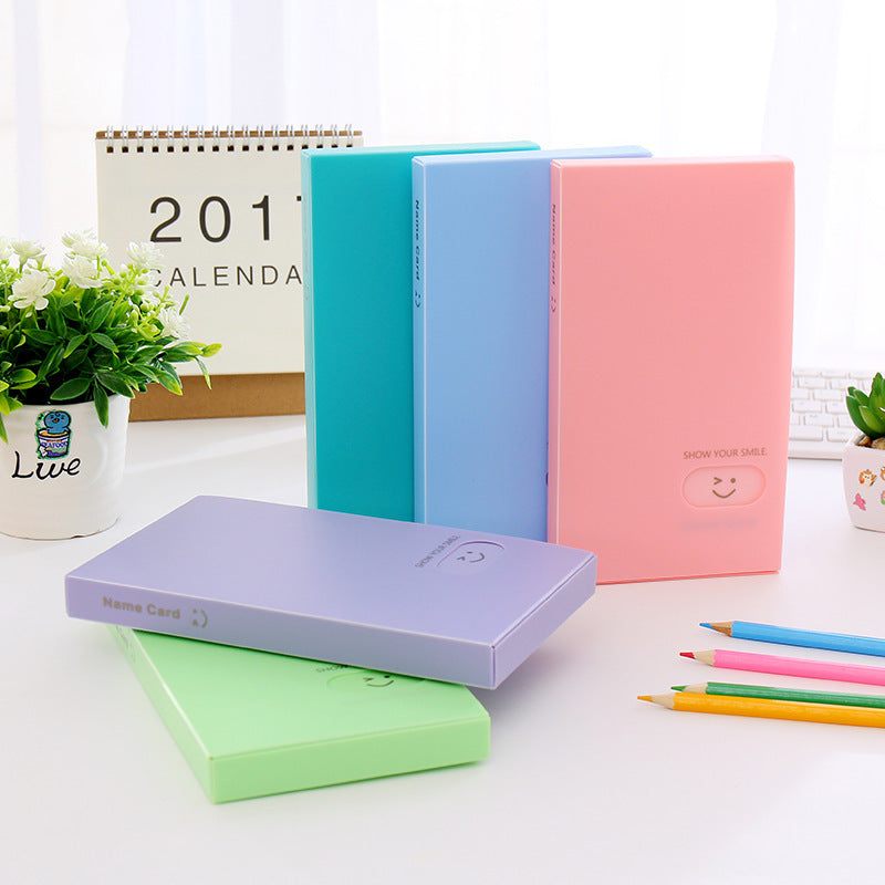 Plastic business card case in pink, open to show cards. Suitable for business gifts.