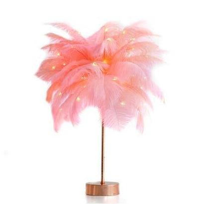 Nordic feather lamp with warm LED lights on a wooden base, perfect for bedroom decoration.