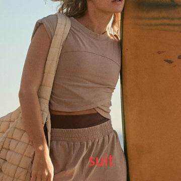 Ladies two-piece set with sleeveless top and sweatpants, dark color, casual style.