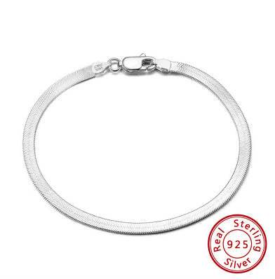 S925 sterling silver flat snake bone bracelet in platinum color, worn on wrist.
