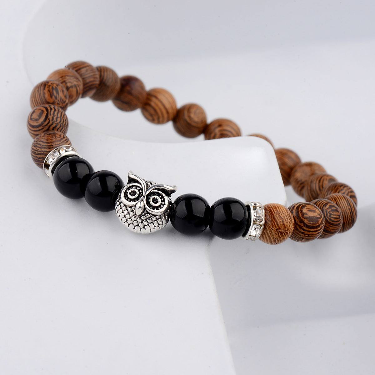 Exotic owl frosted stone bracelet with wood beads in black and gold.