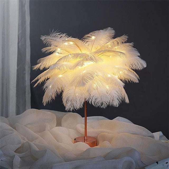 Nordic feather lamp with warm LED lights on a wooden base, perfect for bedroom decoration.