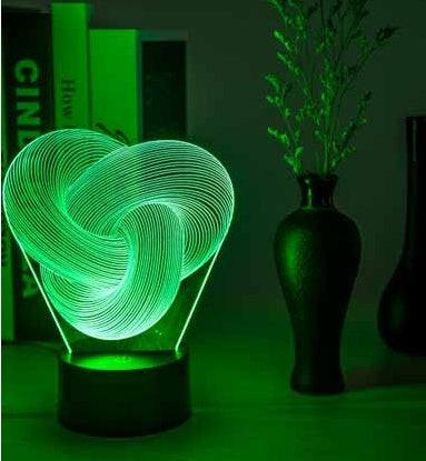 Twist Abstract LED 3D night light on a table with decorative vases, emitting a soft glow.