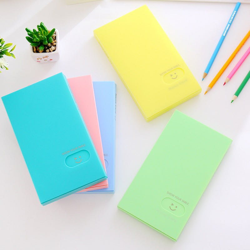 Plastic business card case in pink, open to show cards. Suitable for business gifts.
