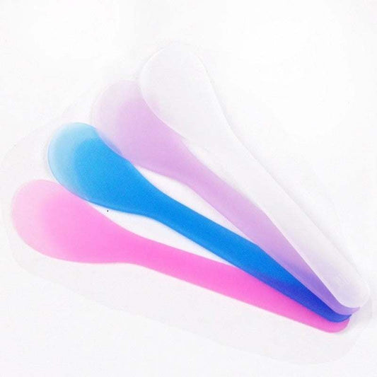 1 Pcs Wax Colorful wax bean spoons in pink, blue, and white.