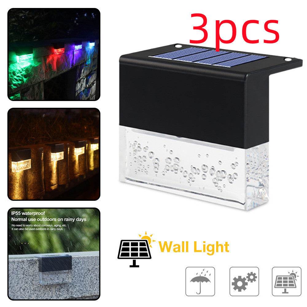 Waterproof New RGB RGB LED solar step lights illuminating a garden fence in multiple colors, waterproof and crystal-like for outdoor decoration.