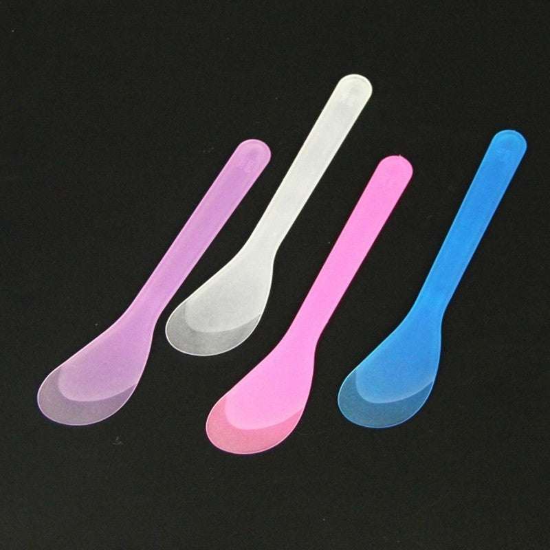 1 Pcs Wax Colorful wax bean spoons in pink, blue, and white.