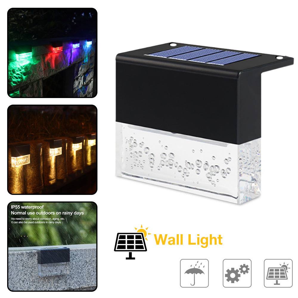 Waterproof New RGB RGB LED solar step lights illuminating a garden fence in multiple colors, waterproof and crystal-like for outdoor decoration.