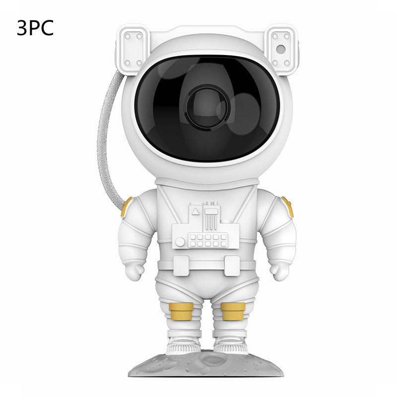Astronaut-shaped galaxy starry sky projector lamp casting colorful nebula effects on walls.