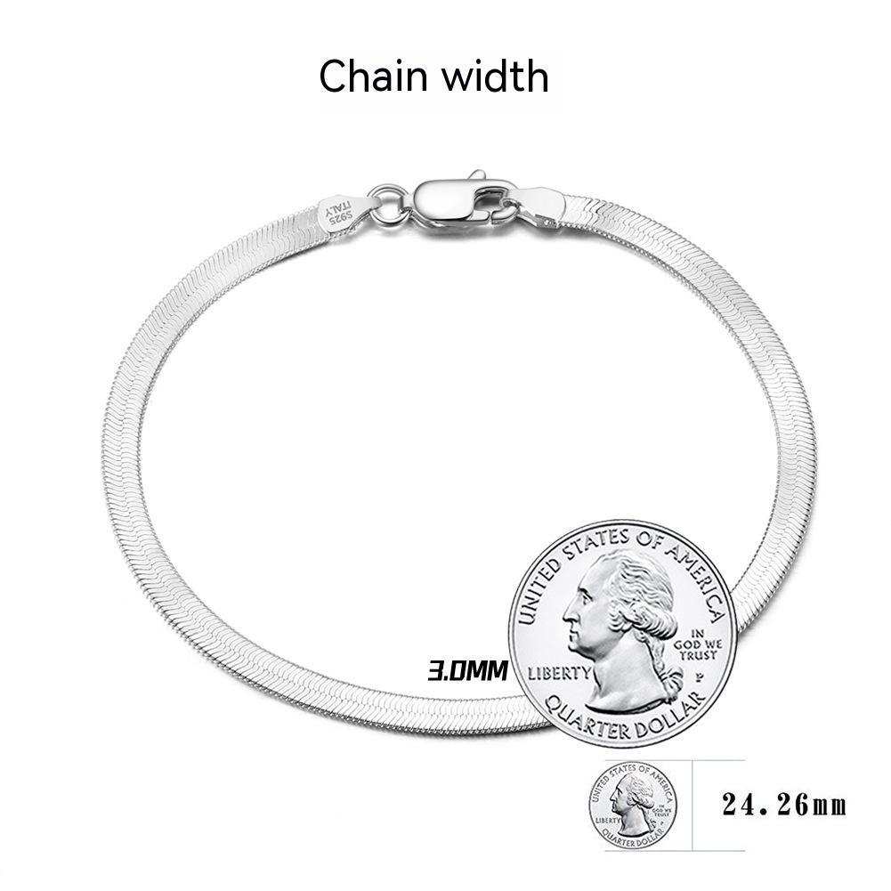 S925 sterling silver flat snake bone bracelet in platinum color, worn on wrist.