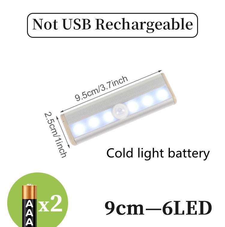 LED sensor light bar emitting warm light under a sofa.